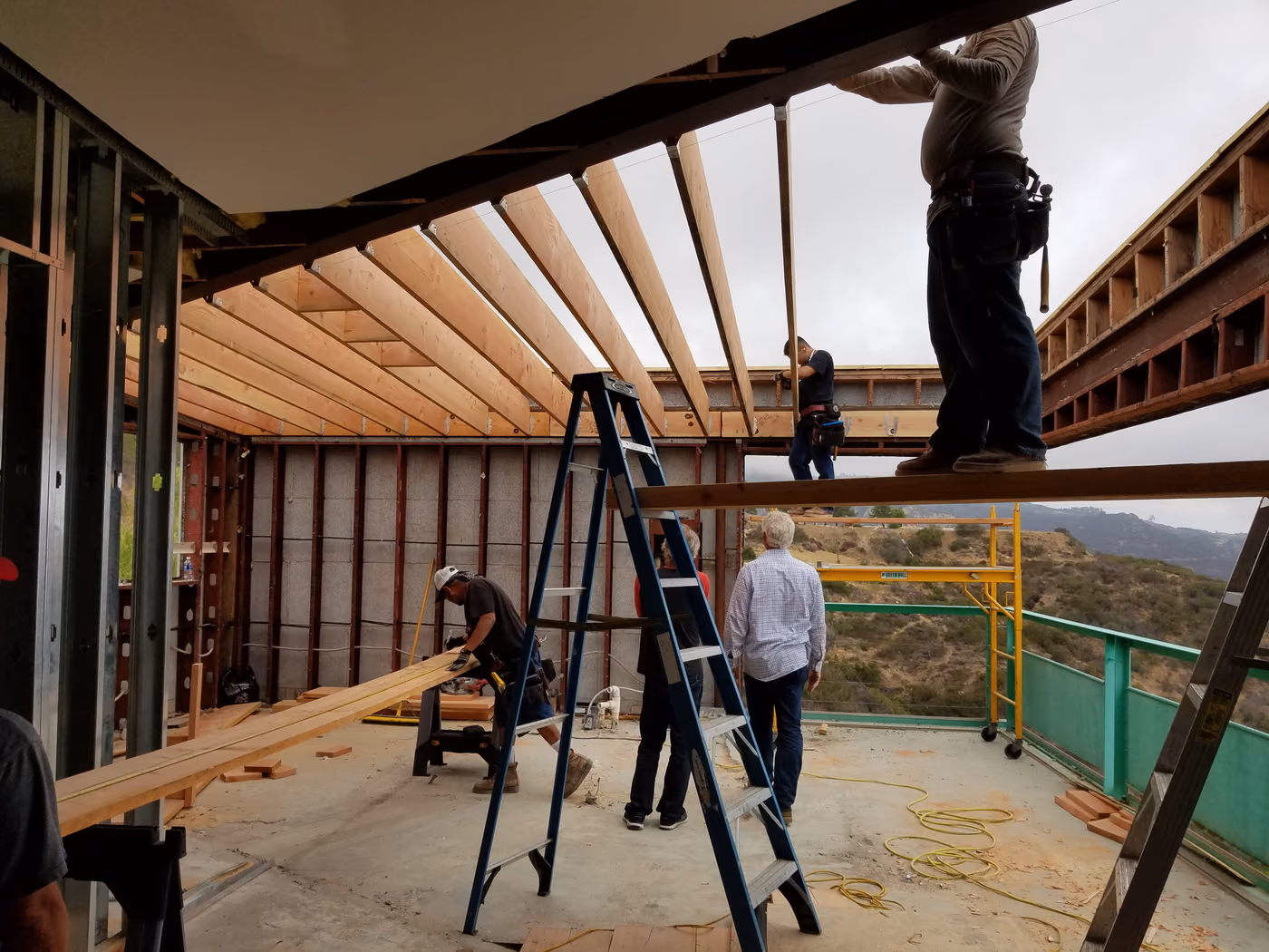 Crew reframing the deck structure at Rambla Pacifico above the canyon