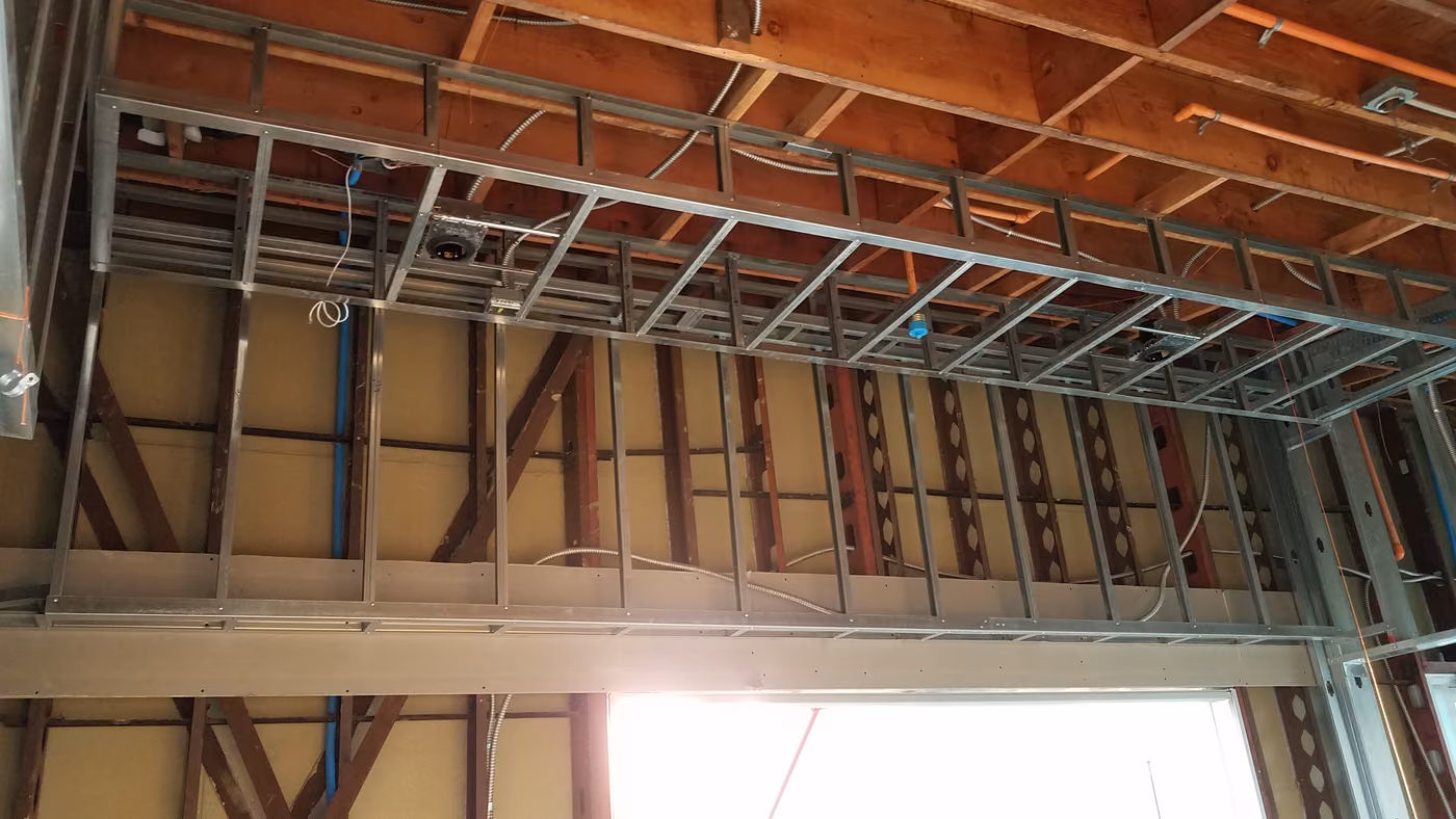 Steel stud framing and rough ceiling structure mid-renovation